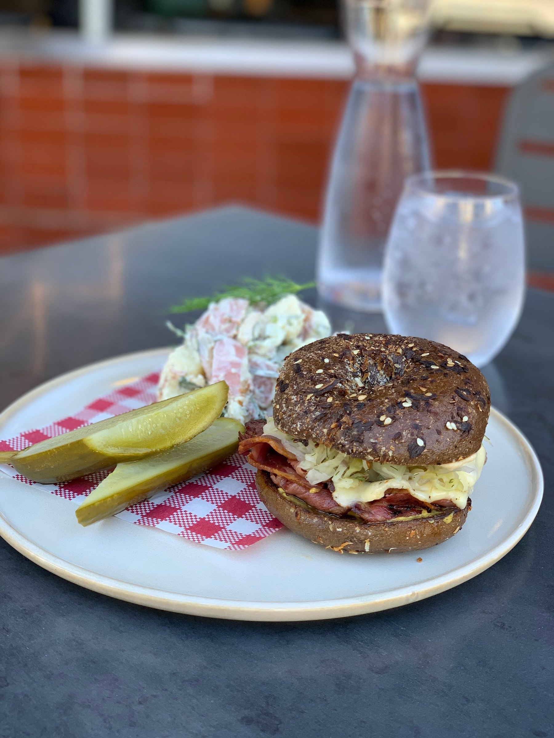 A loaded bagel with a house dill pickle